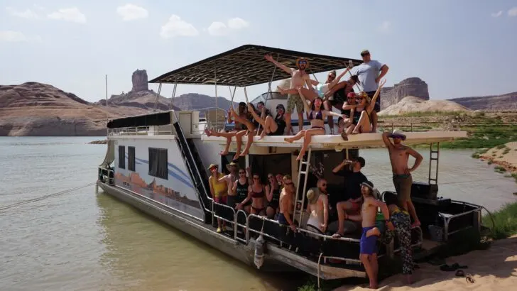 A houseboat on Lake Powell with a large crew.