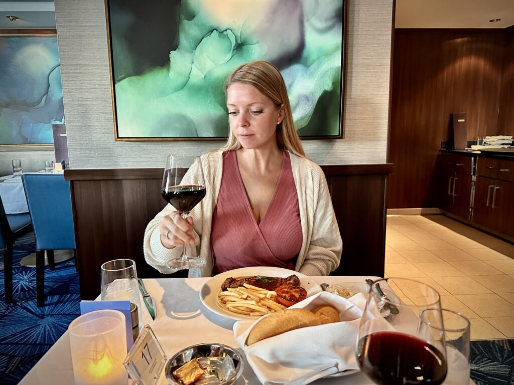 Emily enjoying wine as part of the Free at sea package aboard the Norwegian Jewel Cruise Line
