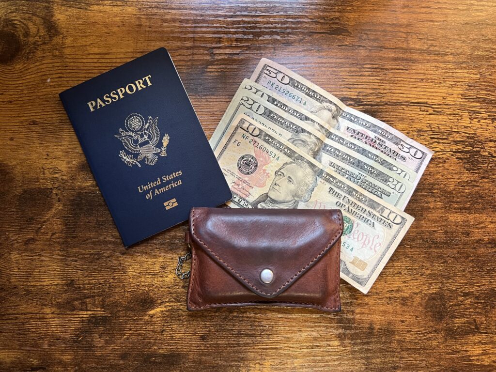 a passport, cash, and wallet which as the essentials for an alaska cruise packing list