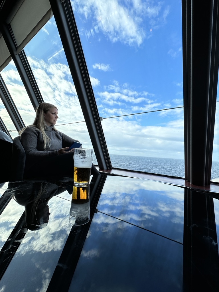 Emily enjoying a "free beer" in the Spinnaker Lounge on the Norwegian Jewel Alaska Cruise