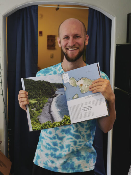 The photographer Jake Junda proudly holding a book he was published in.