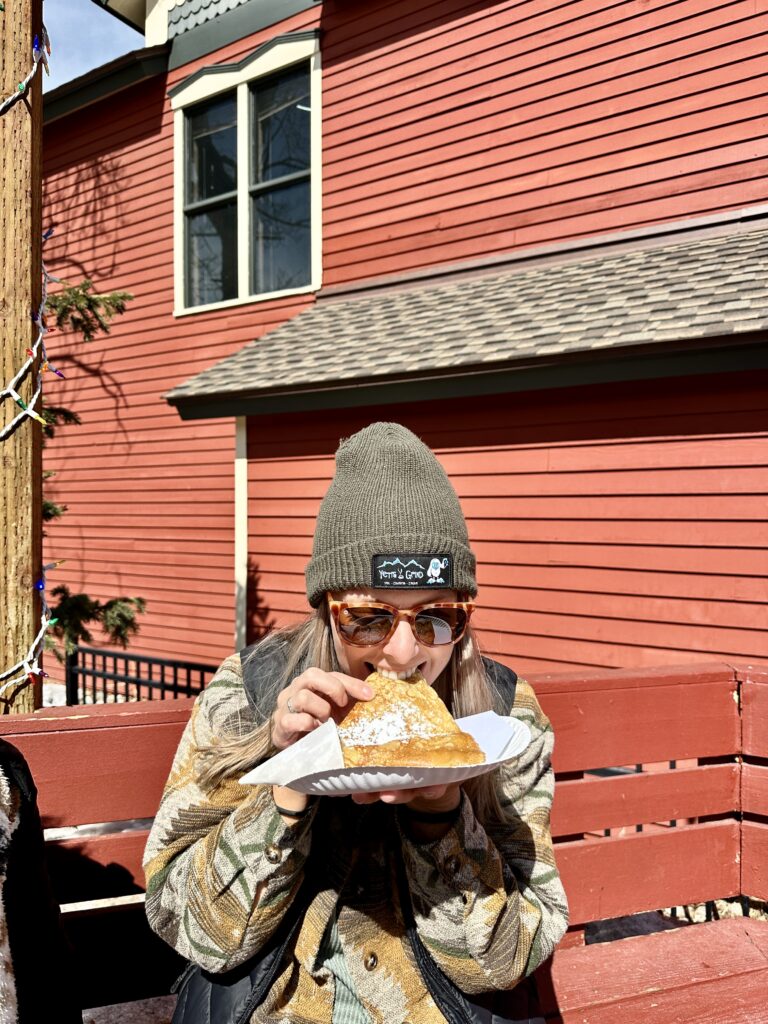 Emily eating a crepe from Crepes A La Cart on Main Street in Breckenridge, CO