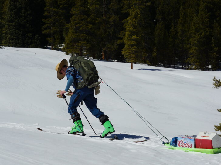 A skier pulling a gear sled.