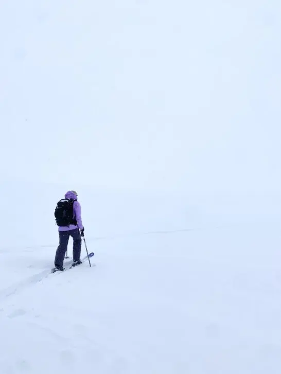A backcountry skier in white out conditions