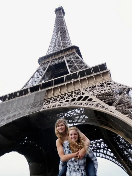 Emily "piggybacking a friend" in Paris under the eiffel town