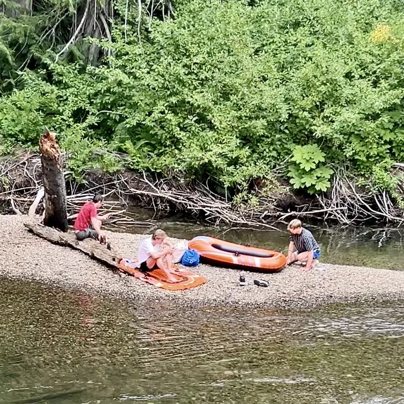 a guy sitting on his popped inflatable kayak down the River of Golden Dreams