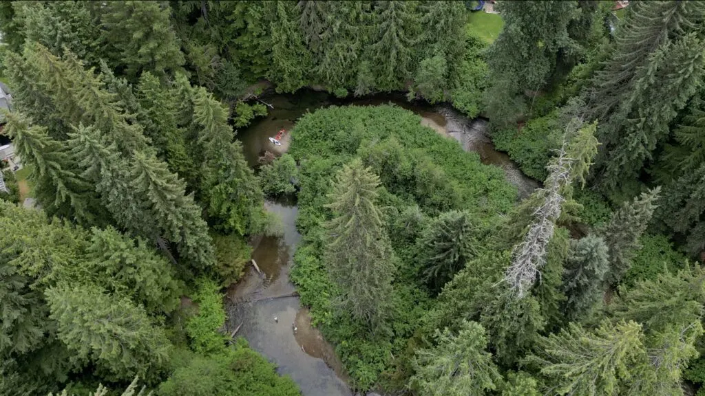 aerial shot of the windy river right before the railway bridge on the river of golden dreams