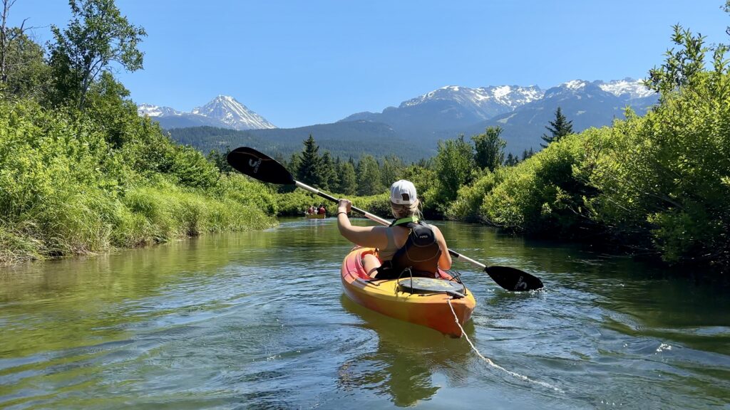 Emily kayaking in a hard-shell kayak down the river of Golden Dreams