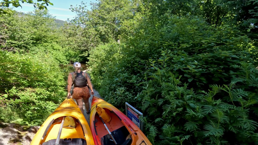 Emily carrying the front of our kayaks to the next put in location on the other side of the fish weir