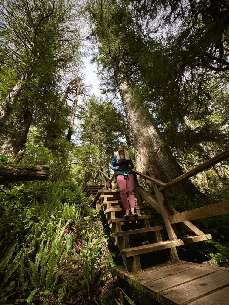 Emily standing along stairs along the Rainforest Trail