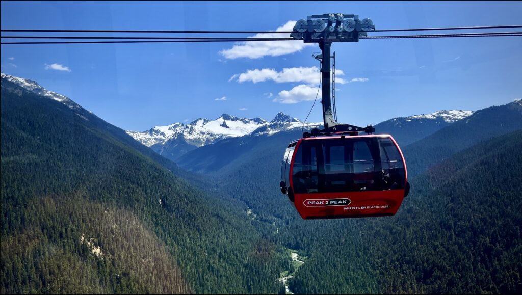 Peak to Peak Express above the ground with mountain views on Whistler Mountain