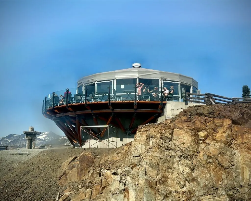 a view of the Umbrella Bar hanging over a cliff on top of Whistler Mountain