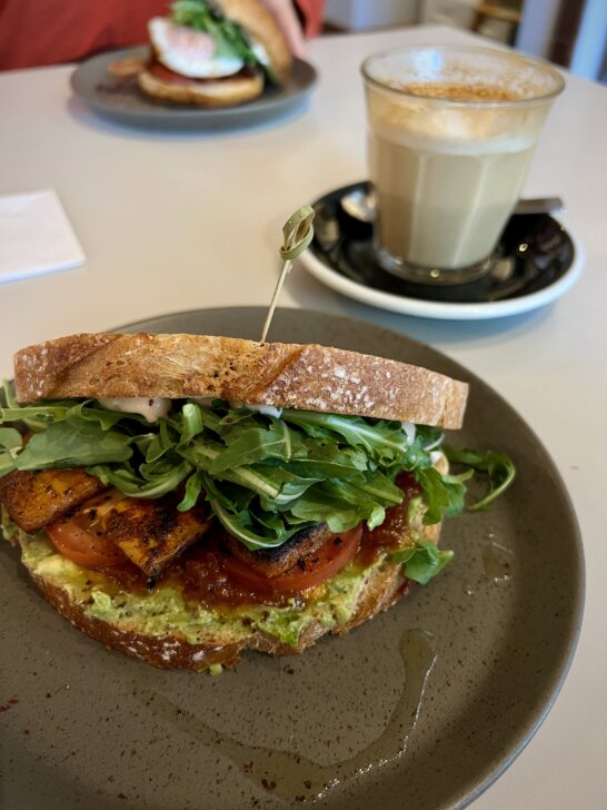 A breakfast sandwich and latte at Dose Coffee