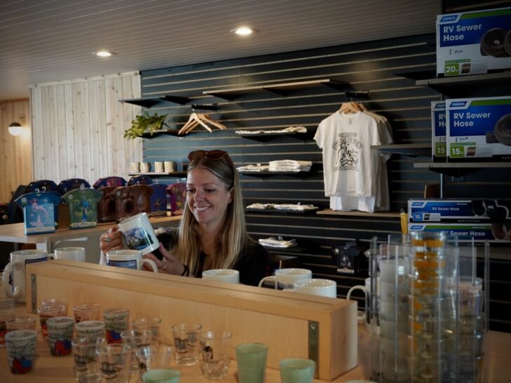 Emily looking at merchandise to purchase inside the Spokane KOA Journey main building