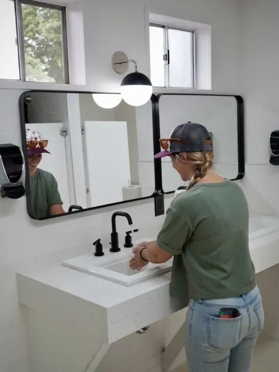 Emily washing her hands at the newly renovated bathrooms near the main entrance of the Spokane KOA Journey