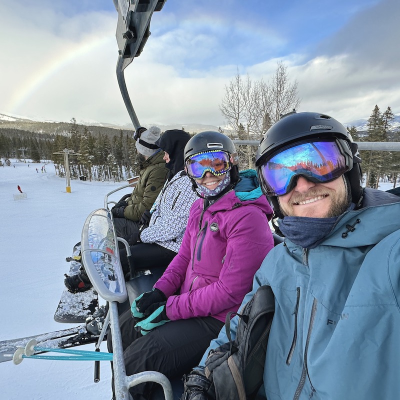 Jake and Emily wearing their neck buffs on the chairlift.