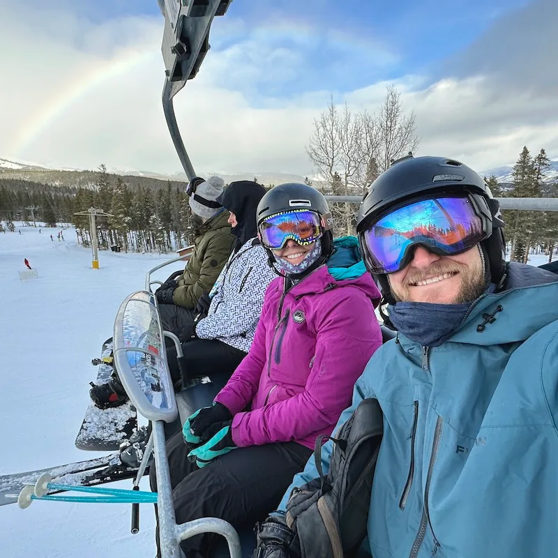 Jake and Emily wearing their neck buffs on the chairlift.