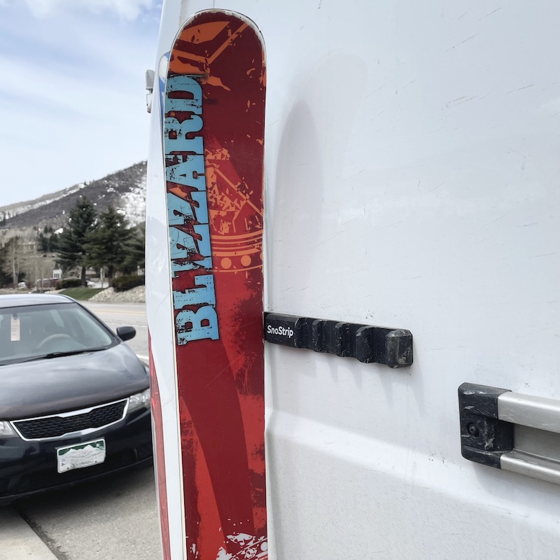 SnoStrip is a temporary ski rack for leaning your skis and snowboards against a vehicle.