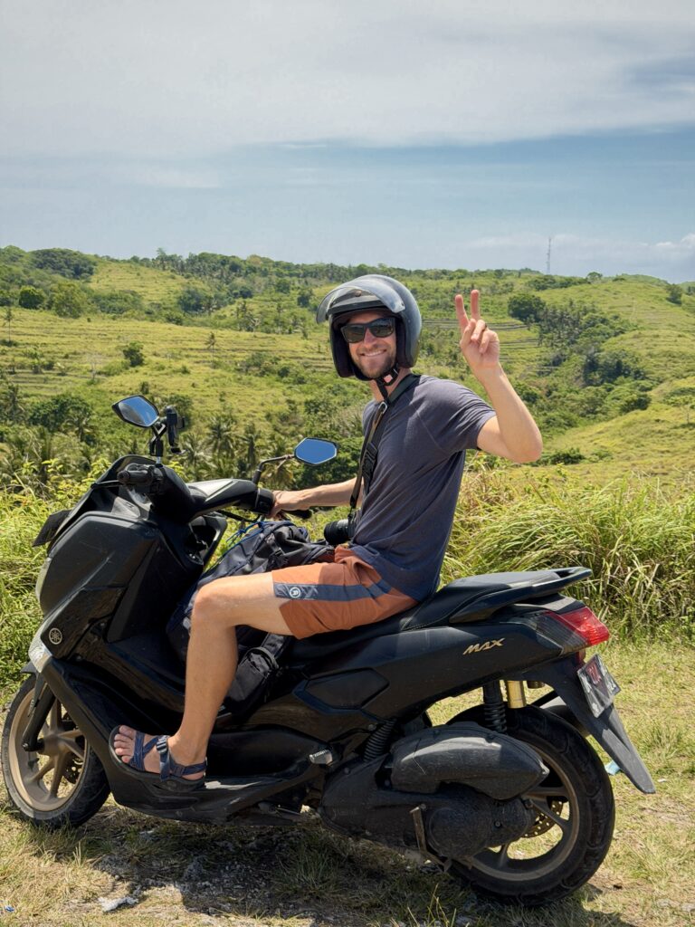 jake on a motorbike with the teletubbie hills behind him