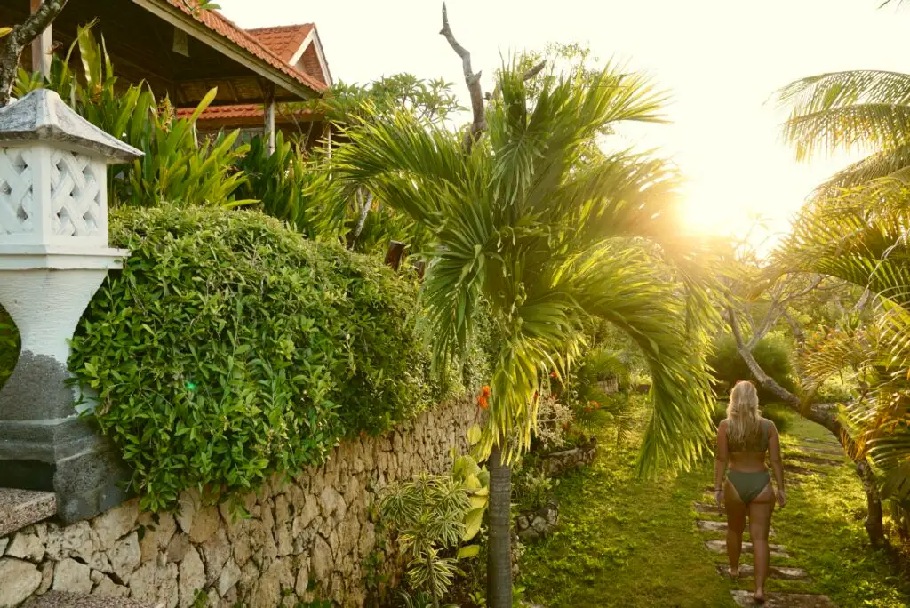 Emily walking along the stone path to the pool at Gara Gara Sea View