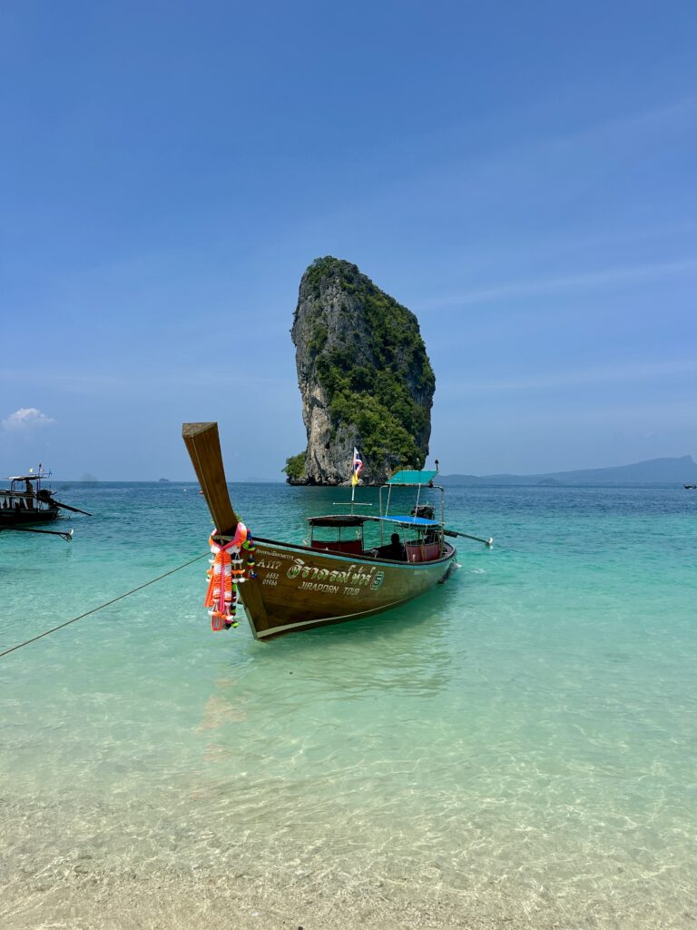 long tail boat sitting in front of Poda Island
