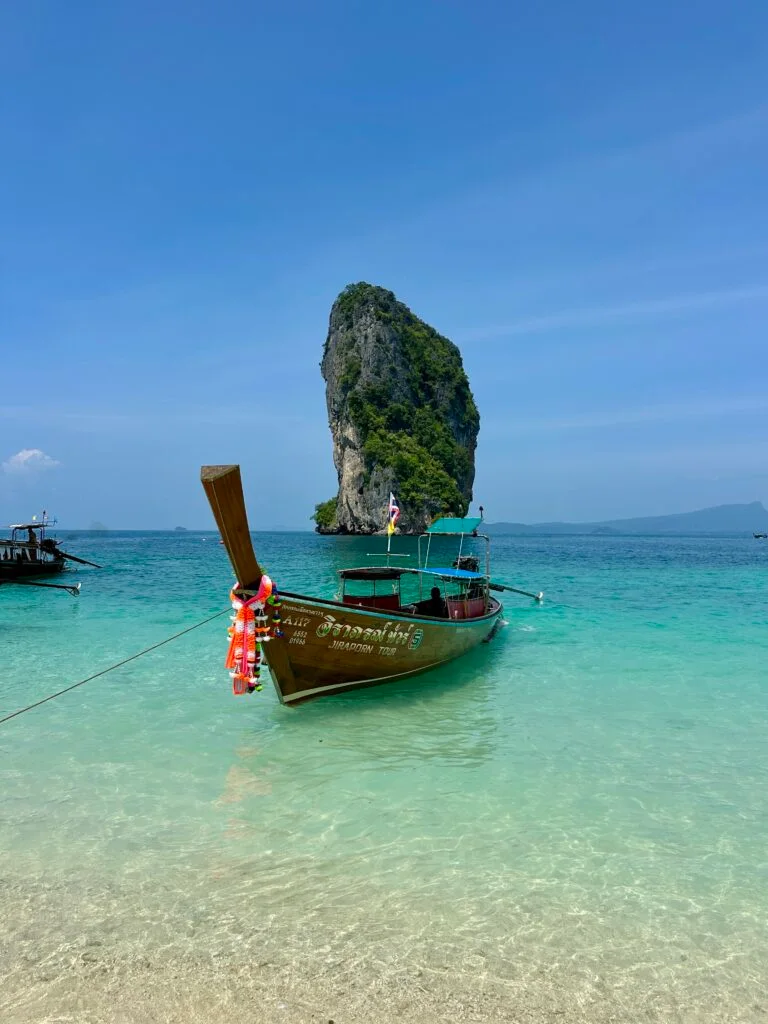 long tail boat sitting in front of Poda Island