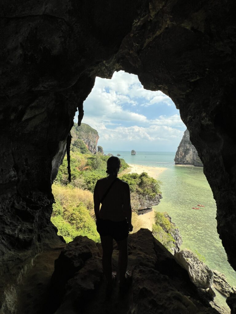 emily looking through the cave out to the beach at phra nang beach