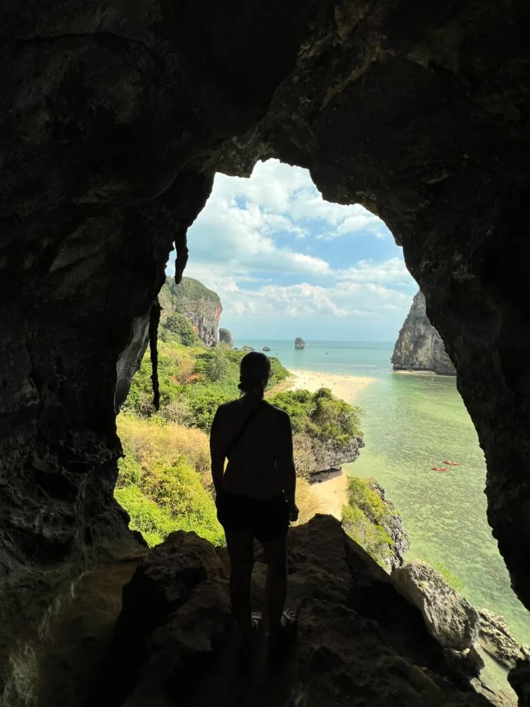 emily looking through the cave out to the beach at phra nang beach